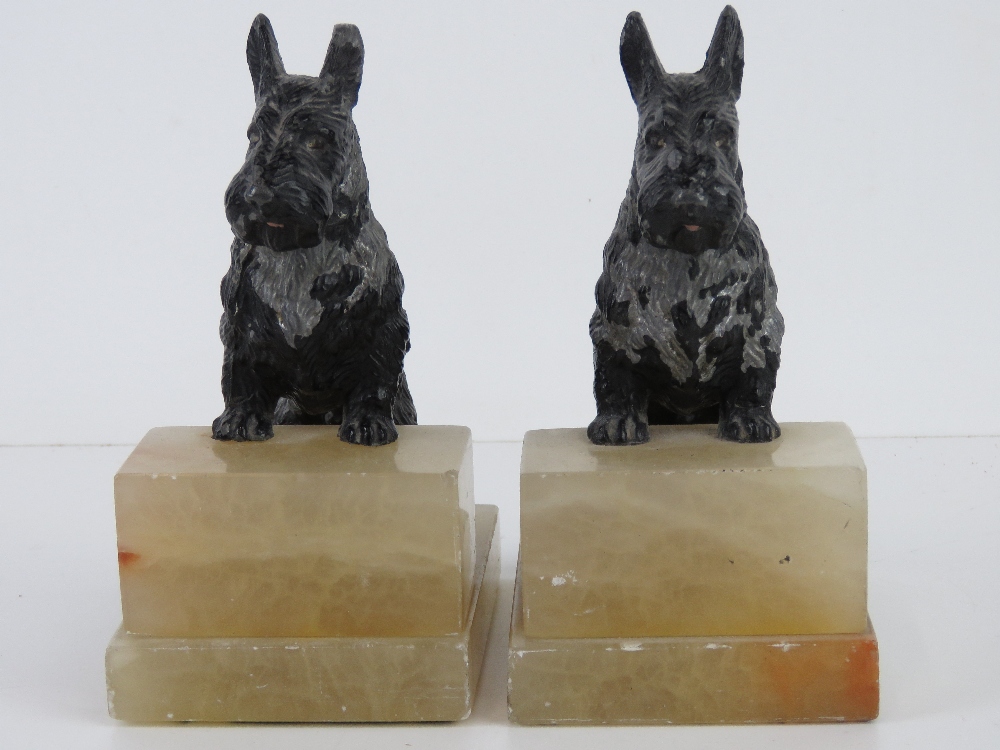 A pair of Scotty dog bookends, each raised over square shaped white onyx stepped base, 16cm high. - Image 2 of 3