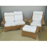 A wicker conservatory suite, late 20th century, two seater settee, chair and footstool,