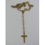 A gilt metal rosary having crucifix upon marked France.