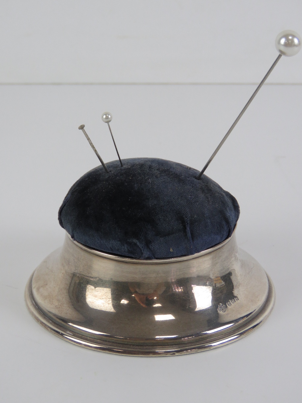 A HM silver hat pin cushion opening to reveal silk lined compartment within, hallmarked London 1901,