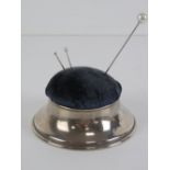 A HM silver hat pin cushion opening to reveal silk lined compartment within, hallmarked London 1901,