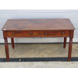 A Georgian mahogany low frieze table having twin drawers and raised over turned octagonal legs,