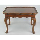 A fine quarter veneered walnut tray table having detachable pie crust tray measuring 53 x 35cm,