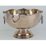 A silver on copper hand chased punch bowl of plain but traditional form having lion mask handles