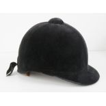 A velvet covered peak riding hat as made by Lock & Co London, size 7.