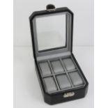 A black leatherette watch box having perspex viewing pane and opening to reveal cushions for six