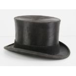 A Moss Bros silk top hat size 7.25.