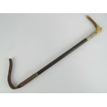 A horn handled and malacca leather tailed riding crop with nickel collar engraved JML,