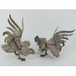 A pair of fighting cocks silver plated table centrepiece decorations, each approx 18cm in length.