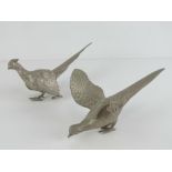 A pair of silver plated table centrepiece fighting pheasant decorations, each approx 23cm in length.