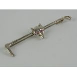 A silver stock pin or brooch in the form of a riding crop having fox mask upon with pink stone eyes,