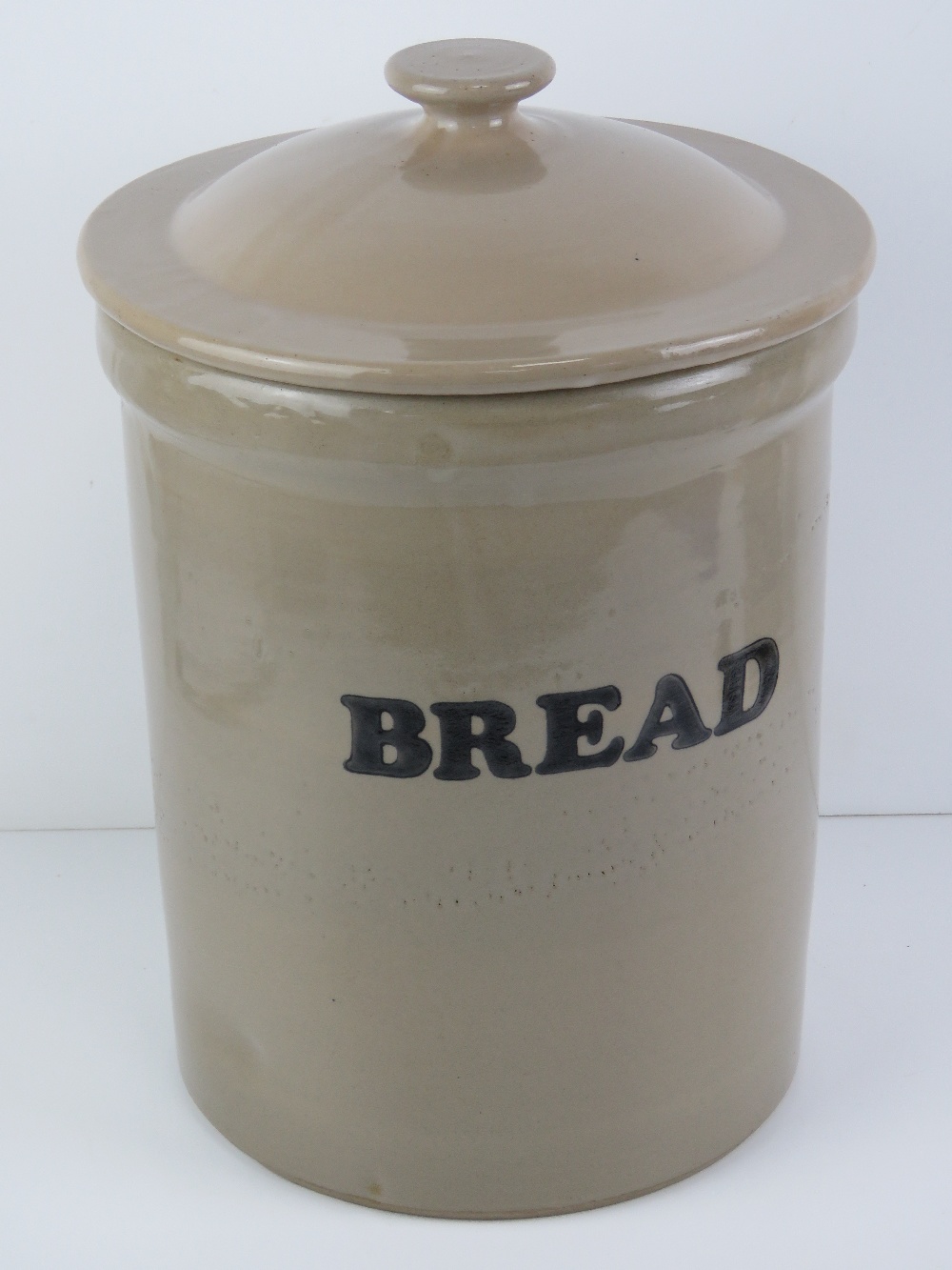 A glazed Stoneware bread bin with lid standing 37cm high.