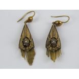 A pair of Victorian yellow metal earrings having seed pearl at centre of enamelled star with fringe