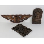 A carved Indo Asian wooden wall plaque having coiled serpent upon, 30 x 17cm high.