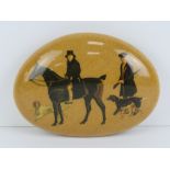 A transfer printed paperweight stone or doorstop featuring huntsman with hunting dogs, 12cm dia.
