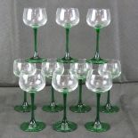 A set of ten green stemmed hock glasses.