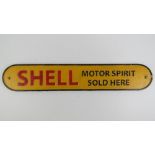A cast metal 'Shell Motor Spirit Sold here' sign in yellow ground, 50cm wide.