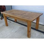 A contemporary solid pine kitchen table raised over substantial square cut legs, 6ft x 3ft.