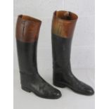 A pair of black and brown leather riding boots,