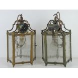 A matched pair of brass and glass pentagonal hall lanterns, each wired for electricity, 32cm high.