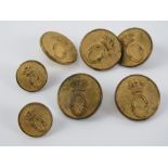 A set of brass Oakley Hunt buttons (five large + two small).