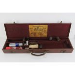 A late 19th / early 20th century 12 gauge leather shotgun case having carry handle and brass locks,
