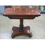 A late Georgian rosewood card table having rotating fold over top opening to reveal red baize,