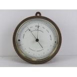 A copper cased Farenheight thermometer and aneroid barometer, wall hanging, 12cm dia.