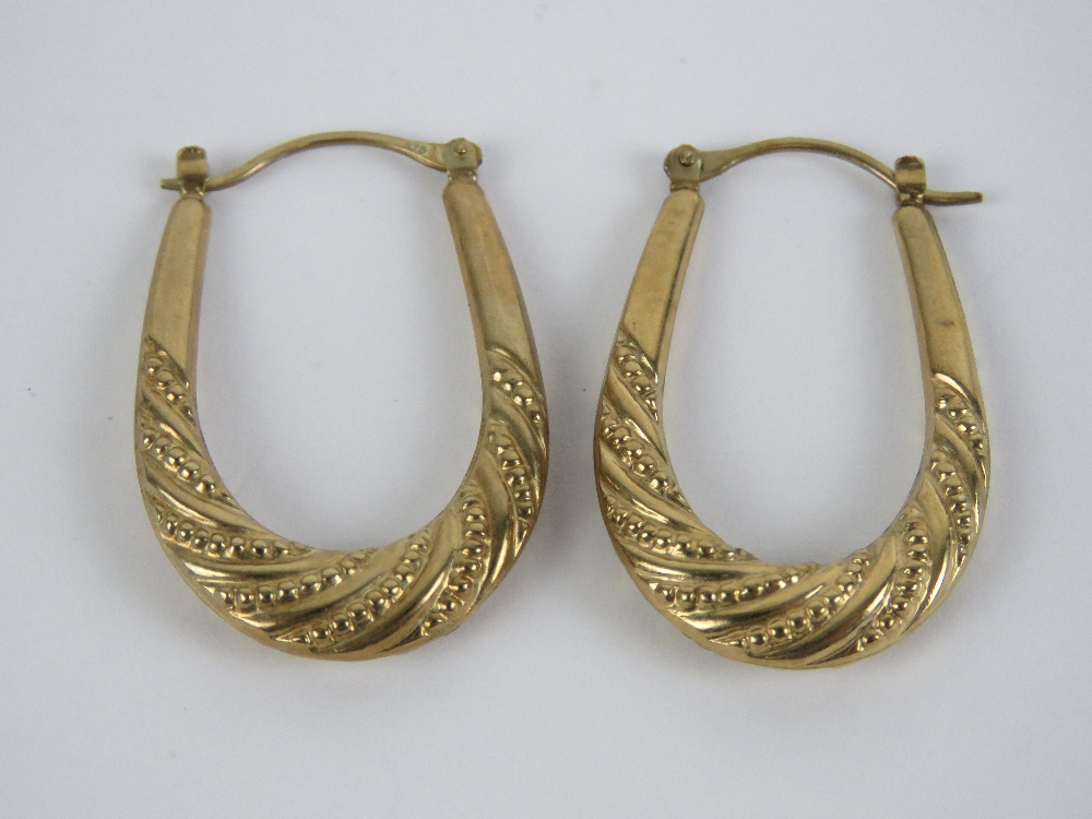 A pair of 9ct gold large oval hoop earrings, stamped 375, 1.9g.