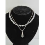 A grey pearl pendant on 925 silver chain together with a grey pearl necklace having 925 silver