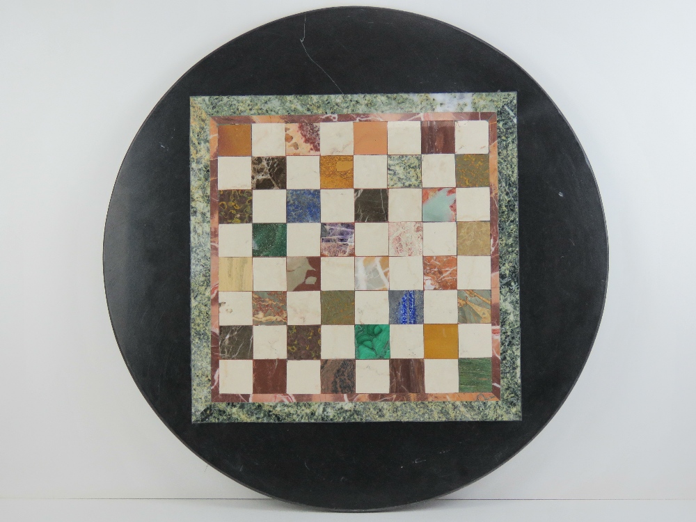 A circular Pietra Dura tabletop having inlaid marble and hardstone specimens in the form of a chess