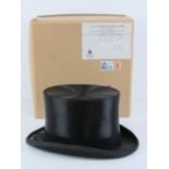 A silk top hat by S Patey London, size 7 1/4, with makers cardboard box with label upon.