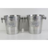 A pair of Laurent Perrier metal champagne ice buckets each standing 20cm high.