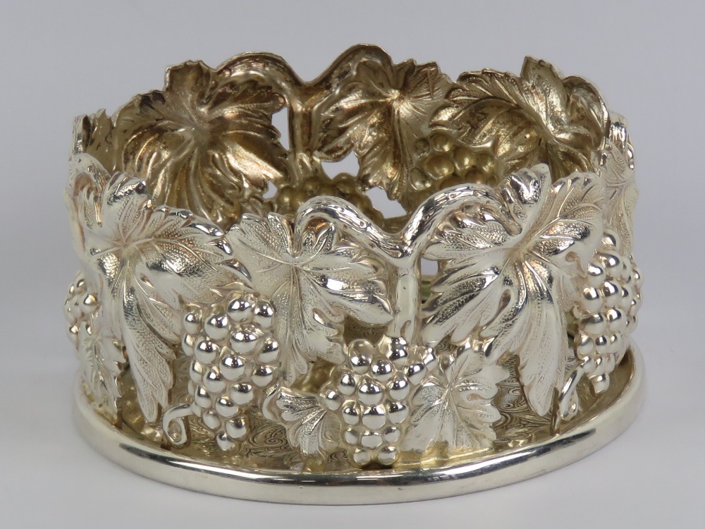 A silver plated wine coaster,