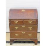 A good short country made 18th century fall front bureau lid lifting to reveal pigeon holes,