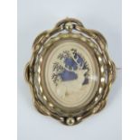 A Victorian pinchbeck swivel brooch having carved bone panel with depiction of a stag upon,