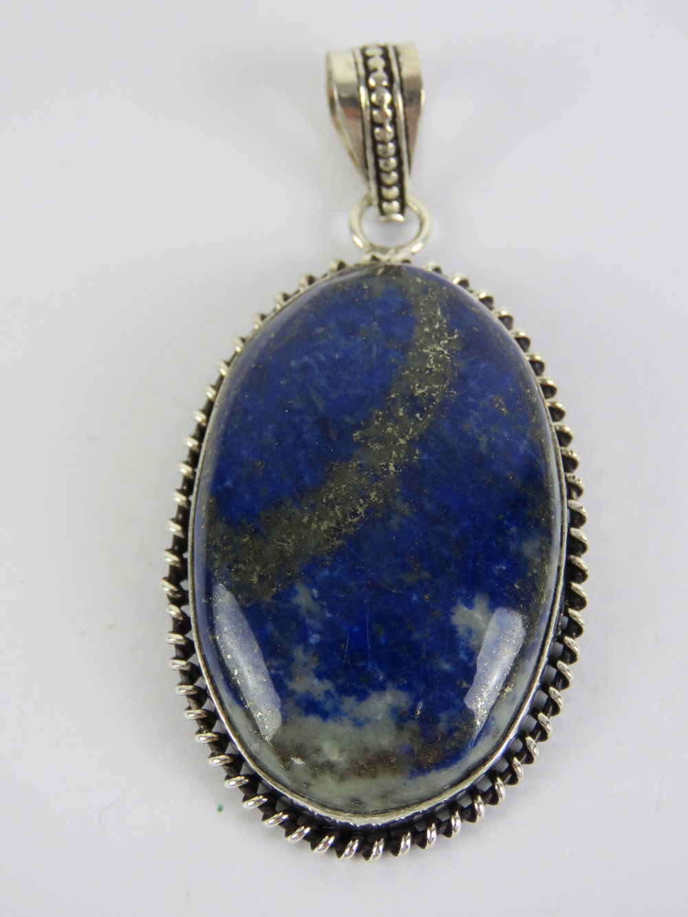 A large lapis lazuli pendant stamped 925 measuring 6cm inc bale.