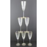 A set of six champagne flutes having gilded rims and each standing 22cm high.