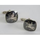 A pair of sterling silver niello cuff links having sagittarious centre with bow and arrow design.