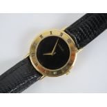 Gucci; a ladies wristwatch having black dial with gold plated chapter ring, marked 3000.2.