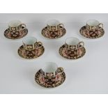 Royal Crown Derby; Six Imari pattern coffee cans and saucers,