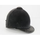 A velvet covered peak riding hat as made by Lock & Co London, size 6 3/4.