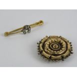 A yellow metal pin brooch having horseshoe upon together with a pinchbeck mourning brooch.