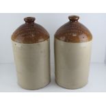 A pair of salt glazed stoneware four gallon jugs having impressed marks for Duckworth & Co Ltd
