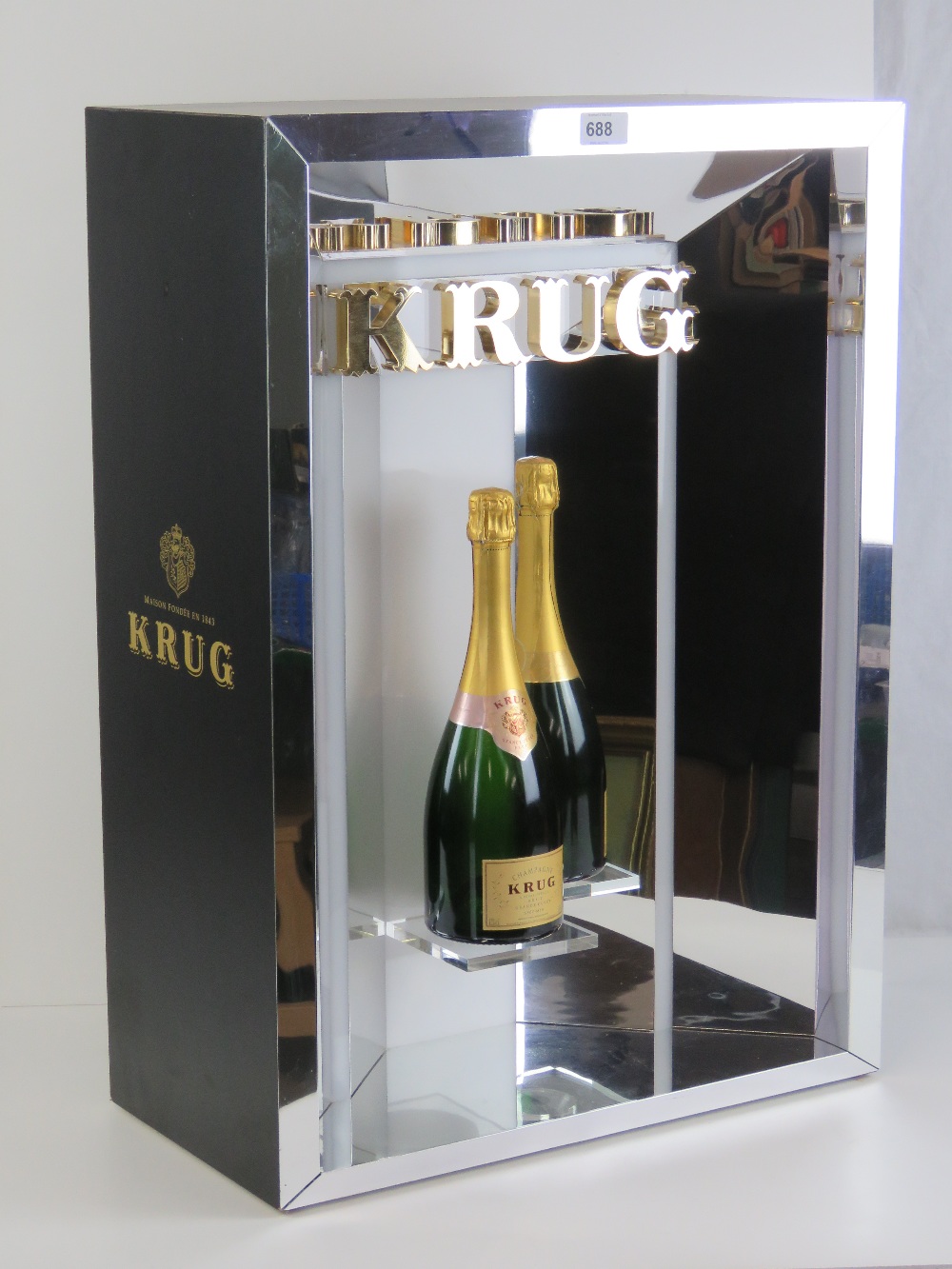 A contemporary illuminated Krug champagne bar display complete with Krug Brut Grant Cuvee display