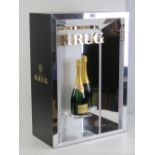 A contemporary illuminated Krug champagne bar display complete with Krug Brut Grant Cuvee display