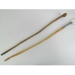 Two riding crops, a short plain stick crop, 28", and a varnished plaited horse hair crop, 28" long.