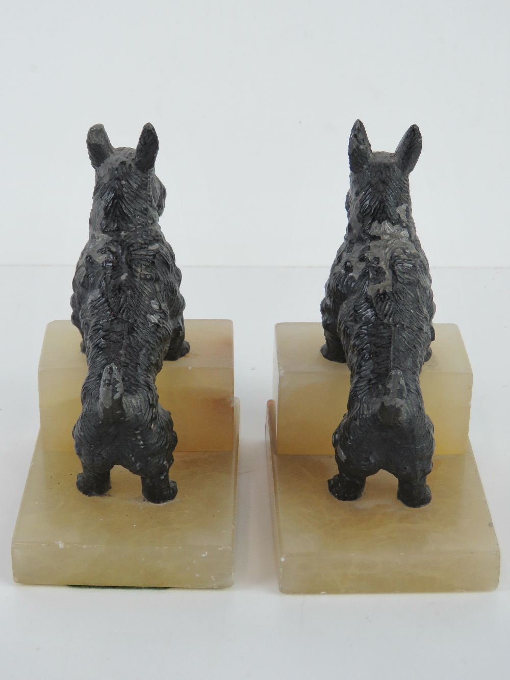 A pair of Scotty dog bookends, each raised over square shaped white onyx stepped base, 16cm high. - Image 3 of 3