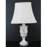 An Italian marble table lamp base or urn form decorated with swags, 31cm high, with shade, a/f.