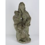 A precast stone garden ornament figurine 47cm high. Seated female with urn.